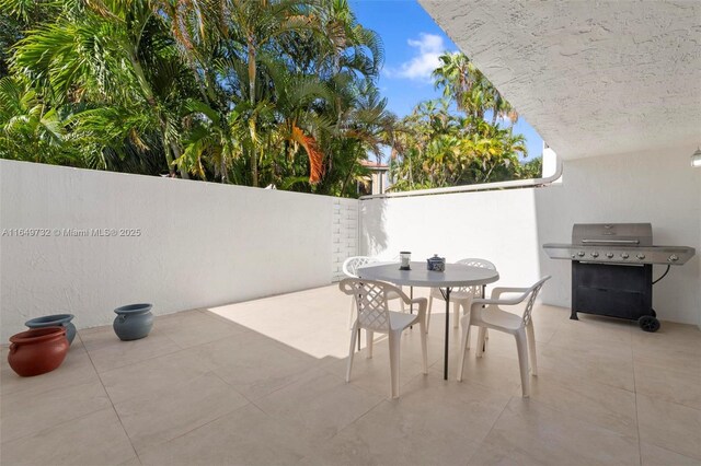 kitchen with backsplash, light tile patterned flooring, white cabinets, and appliances with stainless steel finishes