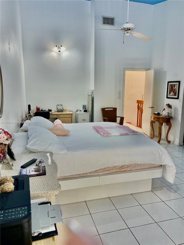 tiled bedroom featuring a high ceiling