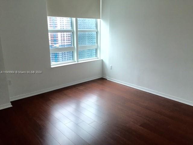 empty room featuring dark hardwood / wood-style floors