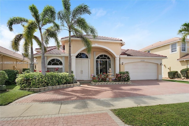 mediterranean / spanish house featuring a garage