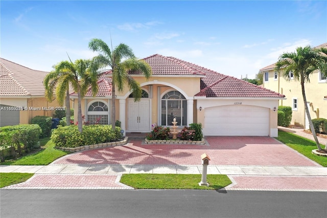 mediterranean / spanish-style house with a garage