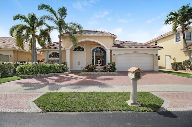 mediterranean / spanish house featuring a garage