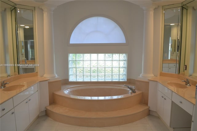 bathroom featuring ornate columns, tile patterned flooring, a washtub, and vanity