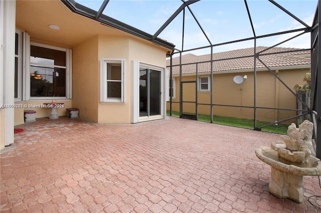 view of patio featuring a lanai