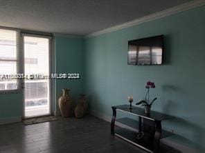 interior space featuring hardwood / wood-style floors and crown molding