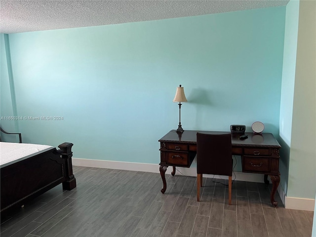 interior space with dark hardwood / wood-style flooring and a textured ceiling