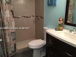 bathroom with vanity, toilet, and a shower with shower curtain