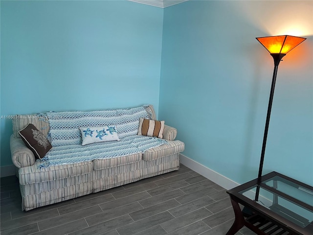 sitting room featuring dark wood-type flooring and ornamental molding