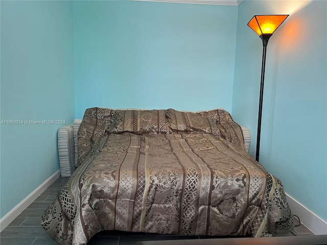 bedroom with ornamental molding and dark hardwood / wood-style floors