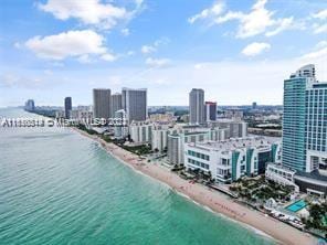 aerial view with a beach view and a water view