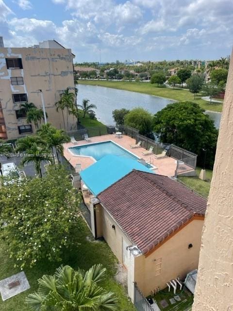 view of swimming pool featuring a water view