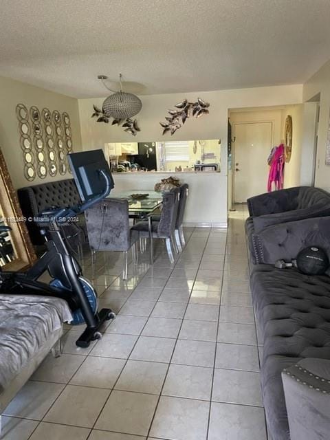 dining space featuring a textured ceiling and light tile patterned flooring