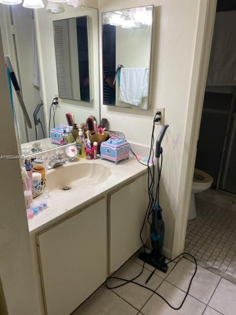 bathroom with vanity, toilet, and tile patterned floors