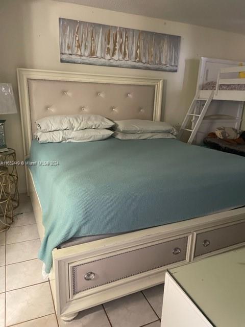 bedroom featuring light tile patterned flooring