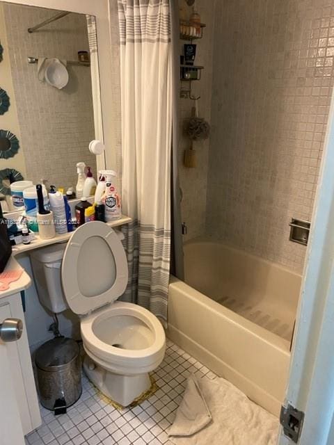 bathroom with tile patterned flooring, toilet, and shower / tub combo with curtain