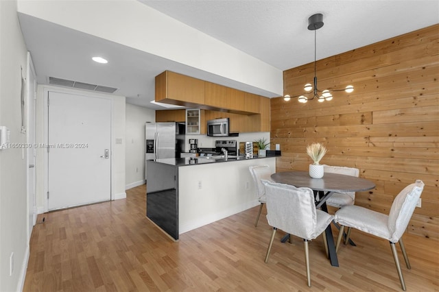 interior space featuring wooden walls and light hardwood / wood-style floors