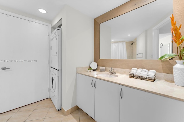 bathroom featuring vanity, tile patterned flooring, and stacked washing maching and dryer