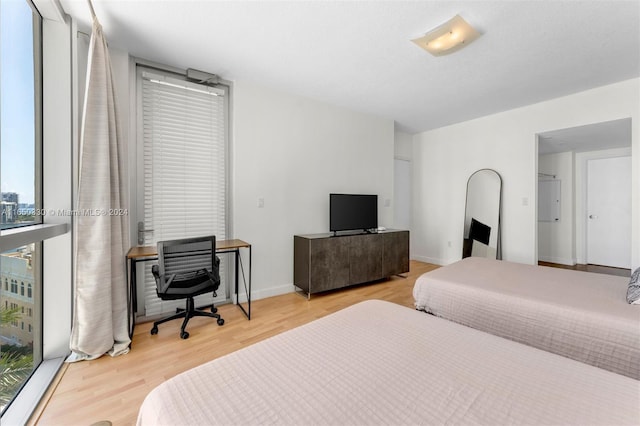 bedroom featuring light wood-type flooring and multiple windows