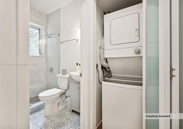 interior space featuring stacked washing maching and dryer and light tile patterned flooring