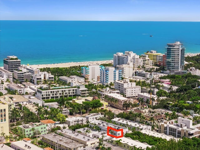 birds eye view of property featuring a beach view and a water view