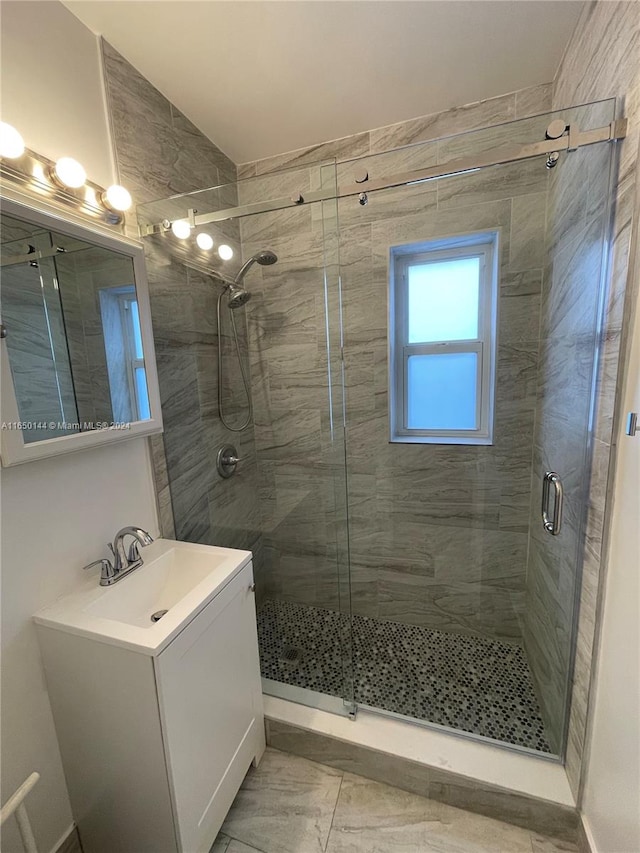 bathroom featuring vanity, tile patterned floors, and a shower with door