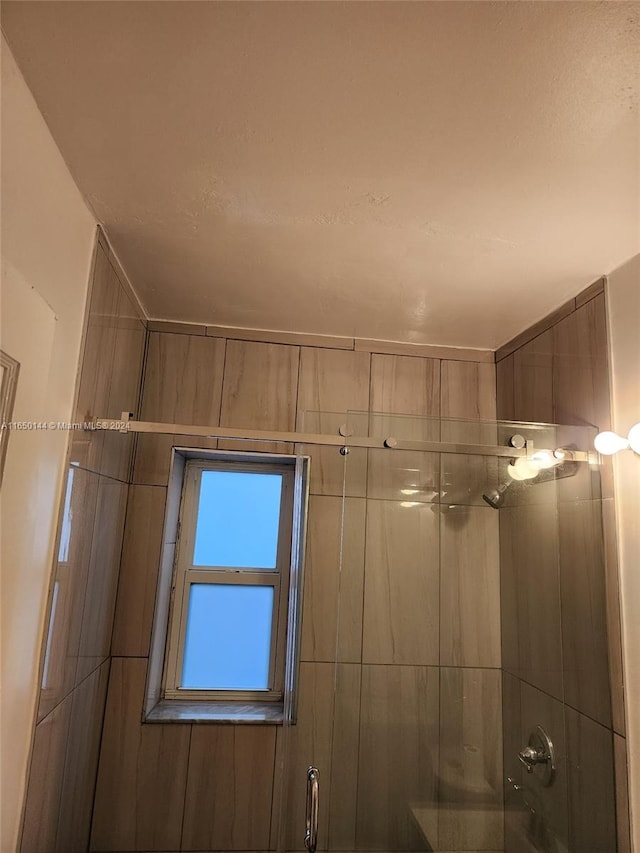 interior space featuring a shower with shower door