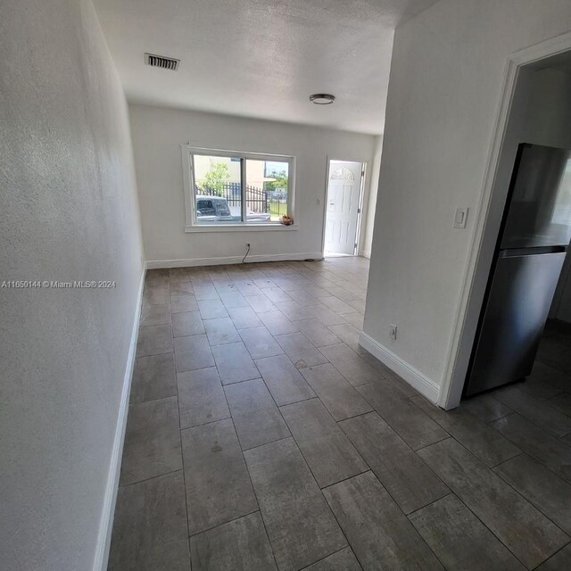 spare room with a textured ceiling