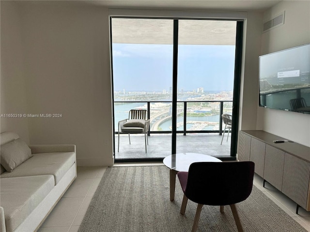 tiled living room featuring floor to ceiling windows