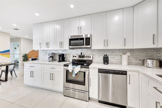 kitchen featuring light tile patterned floors, white cabinetry, and stainless steel appliances