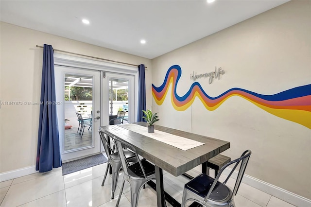 dining area featuring light tile patterned floors and french doors