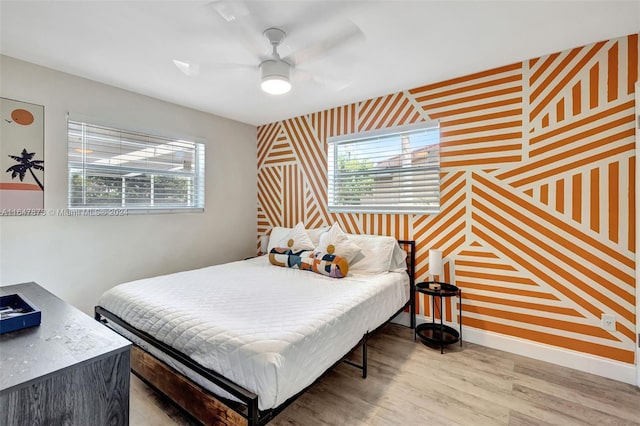 bedroom with wood-type flooring and ceiling fan