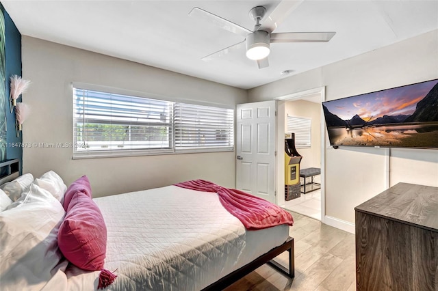 bedroom with ceiling fan and light hardwood / wood-style floors