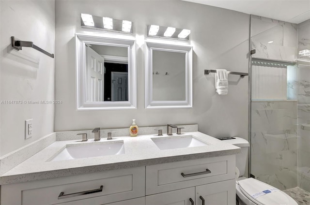 bathroom featuring tiled shower, vanity, and toilet