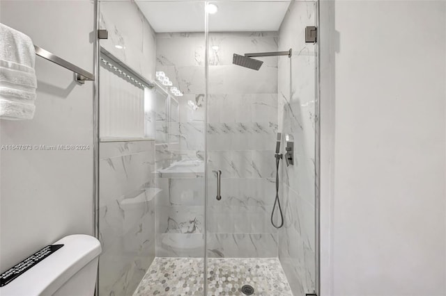 bathroom with walk in shower and toilet