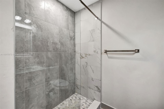 bathroom with tiled shower