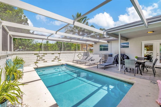 view of swimming pool with a lanai and a patio area