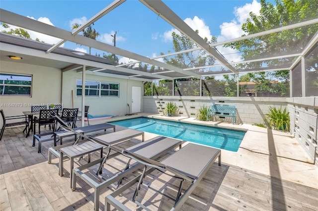 view of swimming pool featuring a lanai