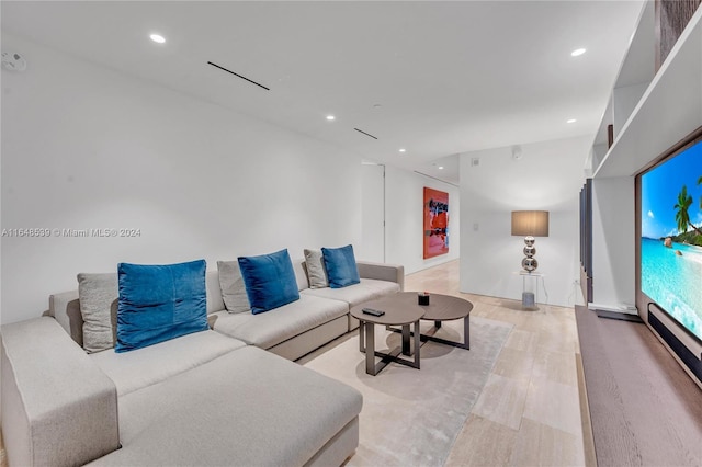 living area with wood finished floors and recessed lighting