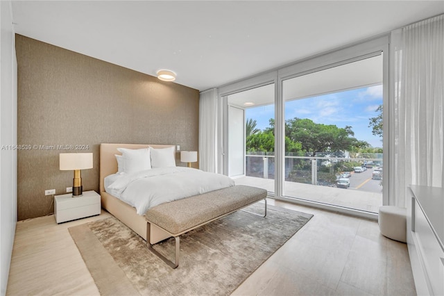 bedroom featuring access to outside and floor to ceiling windows