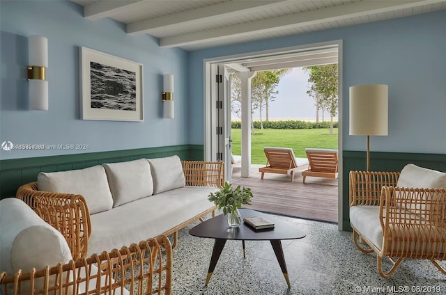 living area featuring beamed ceiling