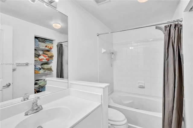 full bathroom featuring vanity, shower / bath combo with shower curtain, and toilet