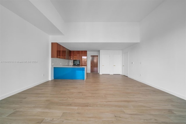 unfurnished living room featuring light hardwood / wood-style floors