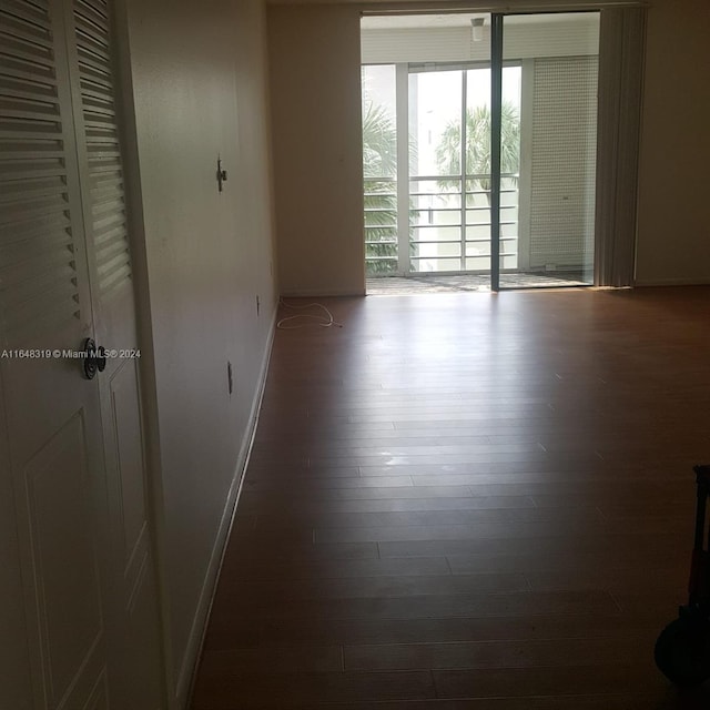 spare room with dark hardwood / wood-style flooring