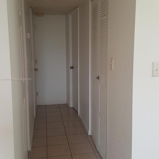 hall featuring light tile patterned floors