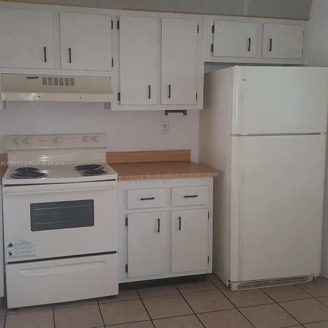 kitchen with white cabinetry, white appliances, exhaust hood, and light tile patterned flooring