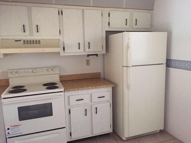 kitchen featuring white appliances, light tile patterned floors, and extractor fan