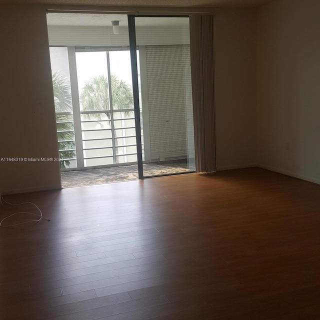 unfurnished room featuring dark hardwood / wood-style floors