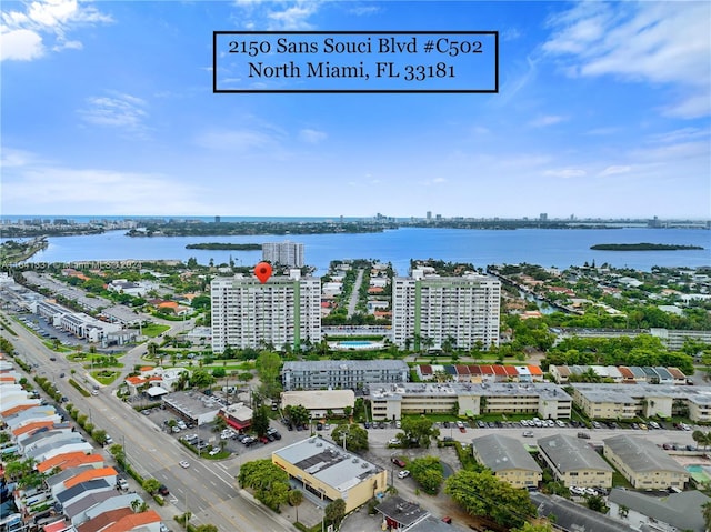 birds eye view of property with a water view and a view of city