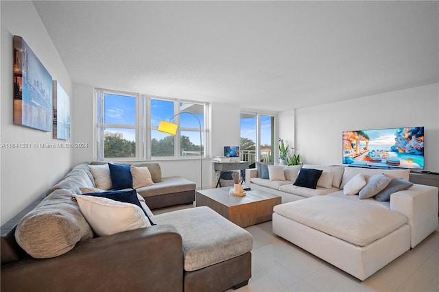 living room featuring a healthy amount of sunlight, expansive windows, and light tile patterned floors