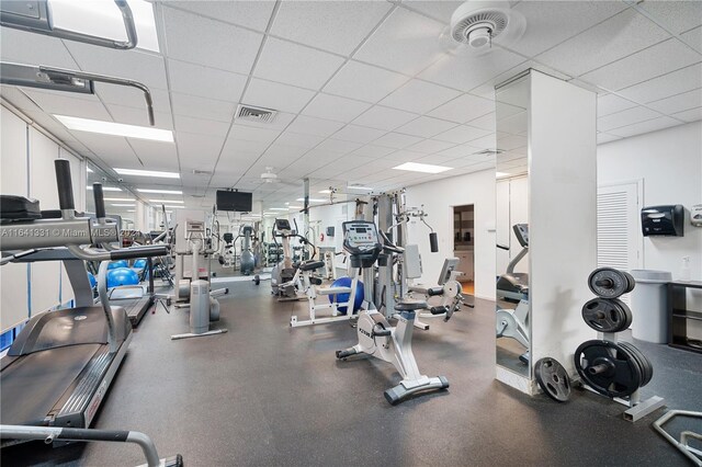 exercise room with a paneled ceiling